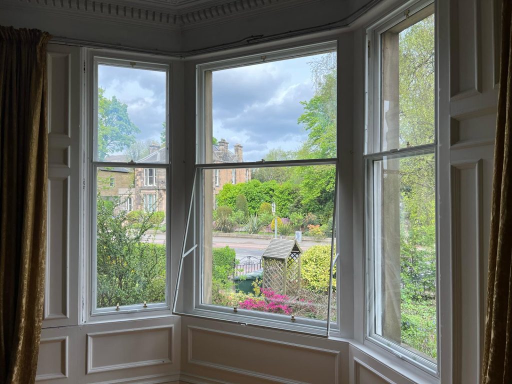 Secondary glazing panel open for ventilation on sash window